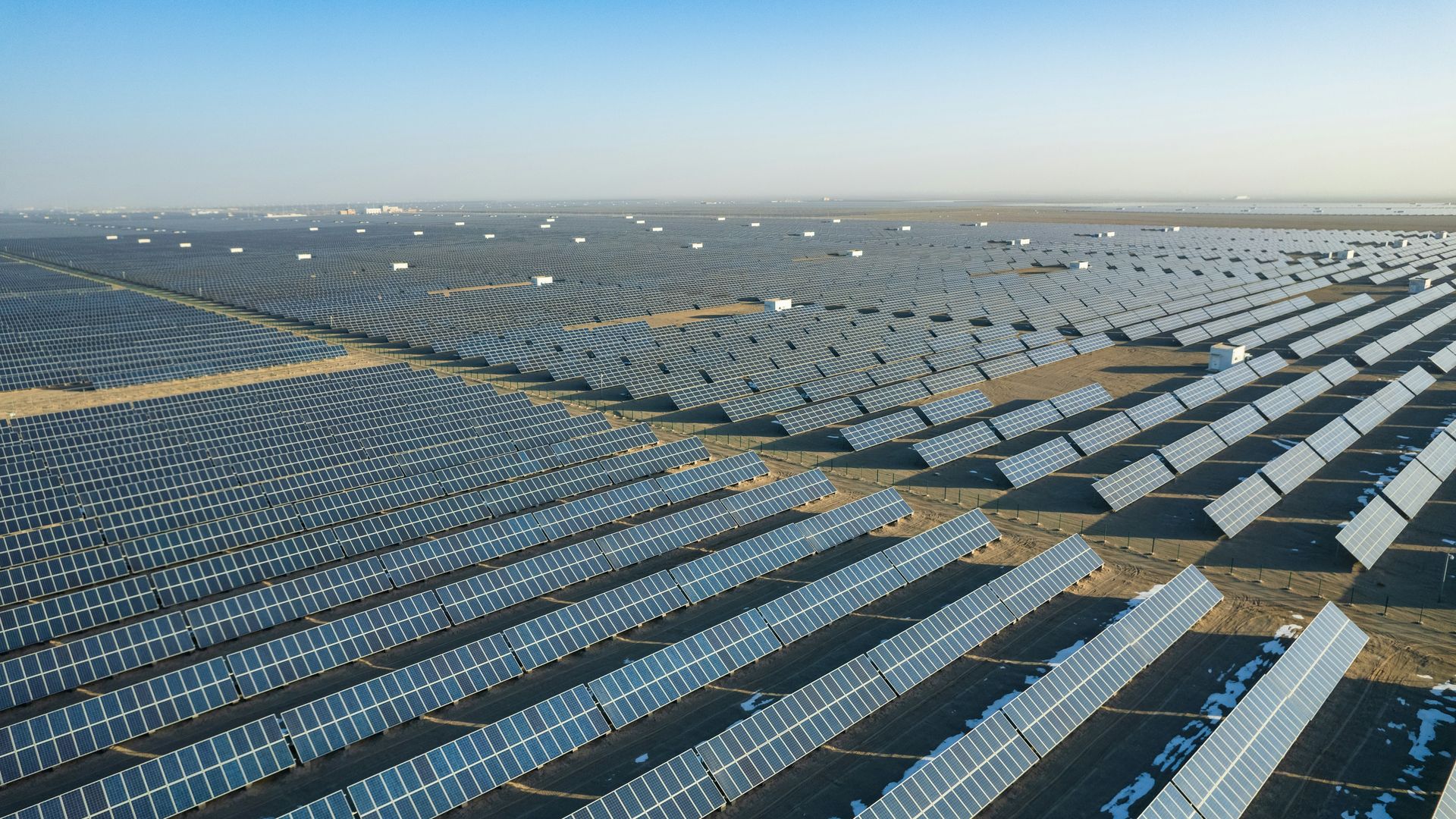 Aerial view of rows of solar panels at a utility-scale solar farm