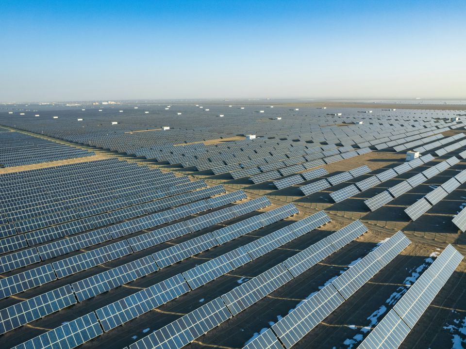 Aerial view of rows of solar panels at a utility-scale solar farm