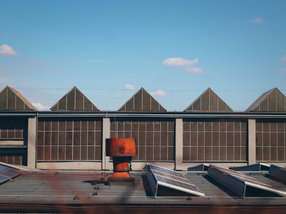 Solar panels installed on the sawtooth roof of an industrial building